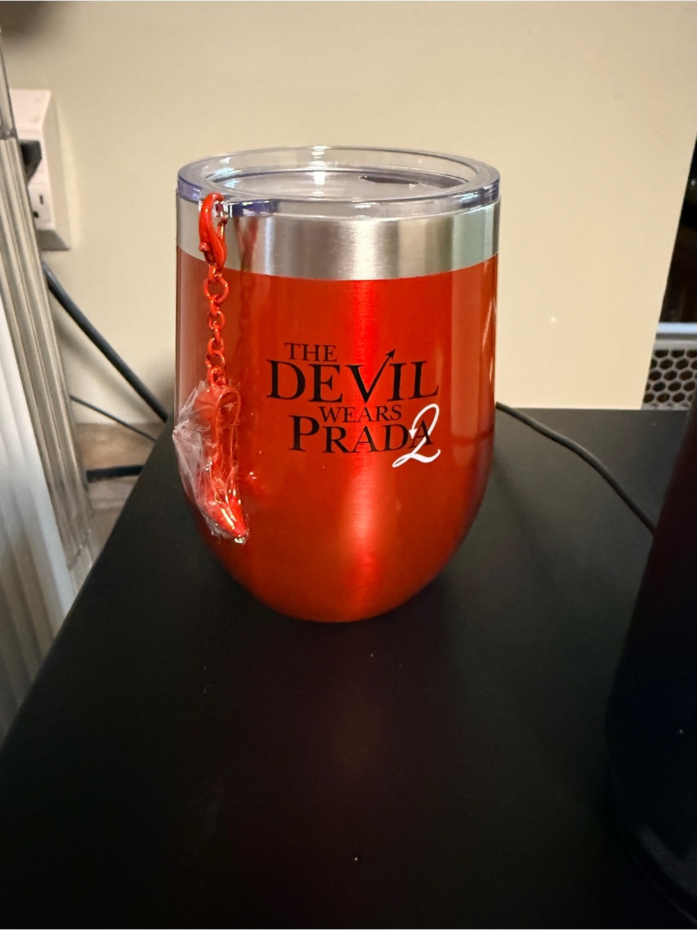 Devil Wears Prada 2 metal tumbler with lid and charm.